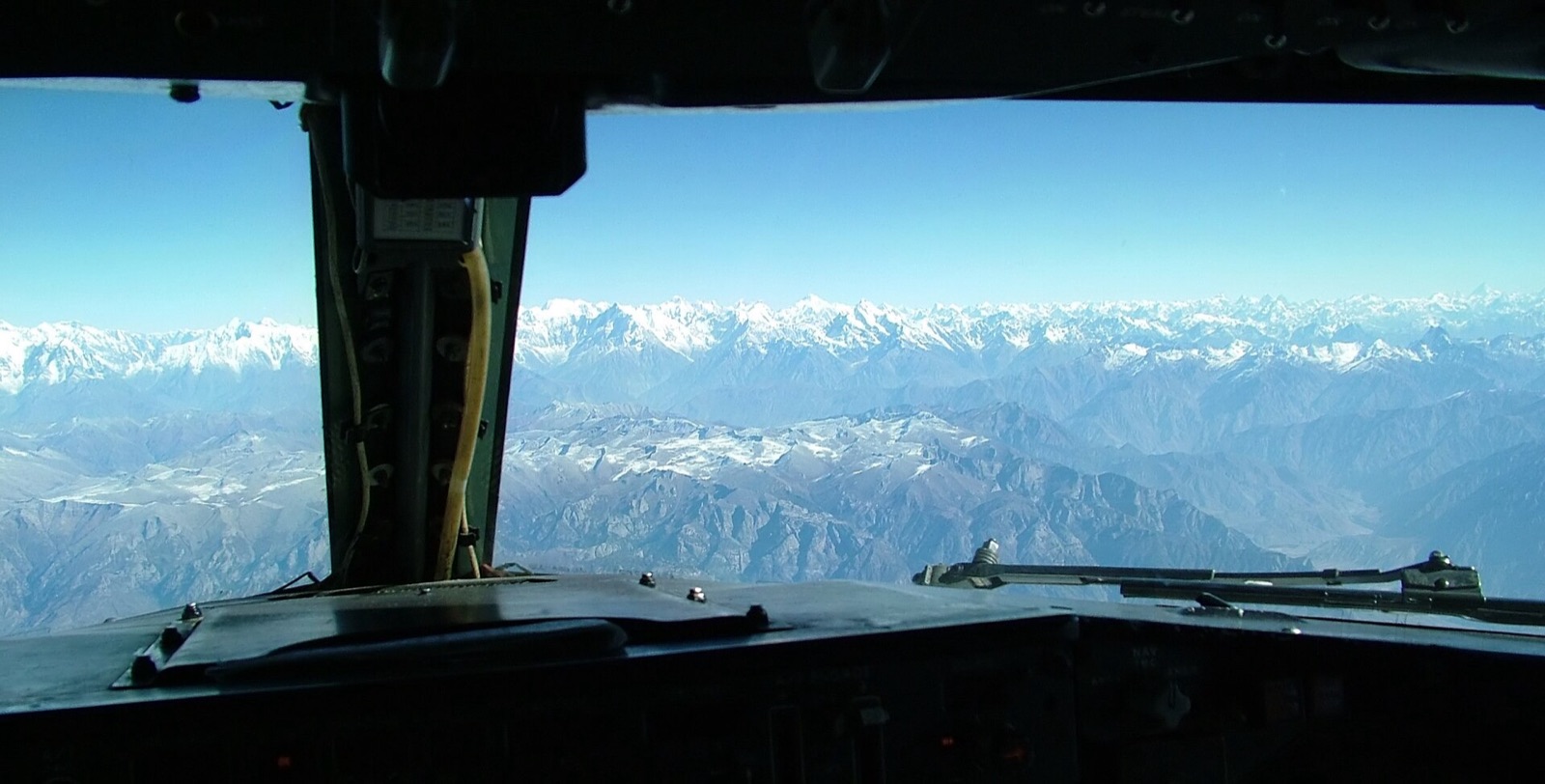View from a cockpit over the instrument panel towards a runway